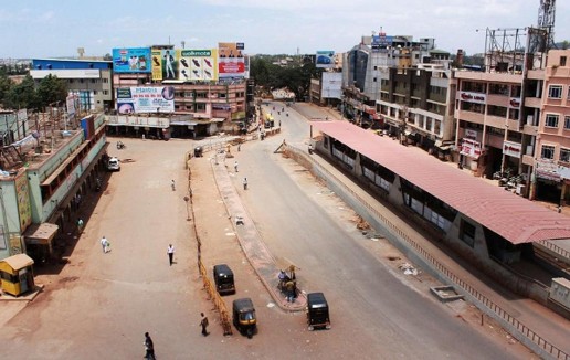 Urban road and commercial area in Doddaballapur, Karnataka, showing ongoing infrastructure and development.